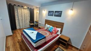 a small bedroom with a bed with blue sheets at Indivar Homestay in Darjeeling