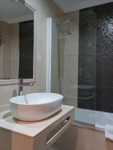 a bathroom with a white sink and a shower at Hotel Rural los Tadeos in Zahara de la Sierra