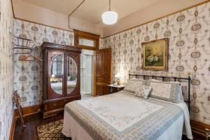 a bedroom with a bed in a room with wallpaper at Cripple Creek Hospitality House in Cripple Creek