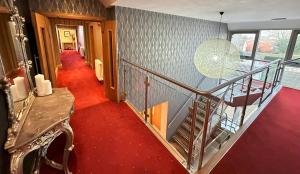 a staircase in a house with a red carpet at The Kings Head Country Hotel in Great Bircham