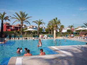a group of people in the swimming pool at a resort at Mar Menor Golf 2 Free Pool, Padel tennis, Gym Yoga etc in Murcia