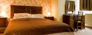 um quarto com uma cama, uma cómoda e um espelho em True Lovers Knot em Blandford Forum