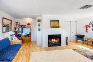 a living room with a blue couch and a fireplace at Mountain Vista - Barn in Hesperus