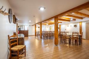 a dining room with wooden tables and chairs at Gite St Joseph gitesdes2vallees in Ventron