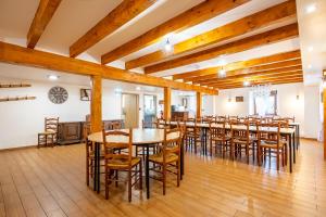 a large dining room with wooden tables and chairs at Gite St Joseph gitesdes2vallees in Ventron