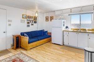 a kitchen with a blue couch and a refrigerator at Mountain Vista - Barn in Hesperus