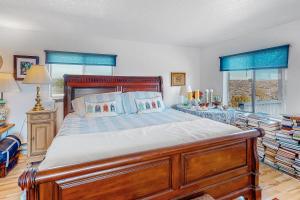 a bedroom with a large wooden bed with blue curtains at Mountain Vista - Barn in Hesperus