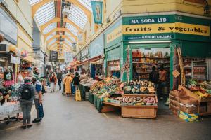 a group of people walking through a market at Arty Escape in Central London - Zone 2 in London