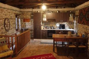 een keuken met een houten tafel in een kamer bij Picturesque double flat country house in Thrapsímion