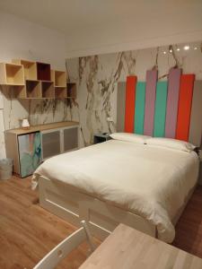 a bedroom with a large bed with colorful headboards at B&B Confort in Reggio di Calabria