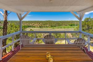 a porch with two chairs and a table with a view at Mountain Vista - Main House in Hesperus