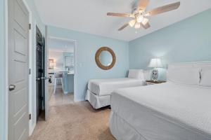 a bedroom with two beds and a ceiling fan at Bring Your Boat! 2br/2ba Condo on the Bay! in Orange Beach