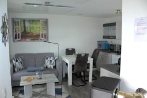 a living room with a couch and a table at Harzidyll-Meinecke in Blankenburg