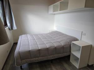 a small bedroom with a bed and a white cabinet at Campeggio Gianna Golfo dei Poeti in Lerici