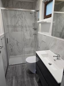 a bathroom with a shower and a sink and a toilet at Campeggio Gianna Golfo dei Poeti in Lerici