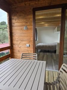 a room with a table and chairs and a bedroom at Campeggio Gianna Golfo dei Poeti in Lerici