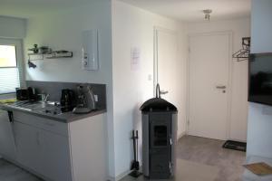 a kitchen with a stove in the corner of a room at Harzidyll-Meinecke in Blankenburg +15 photos
