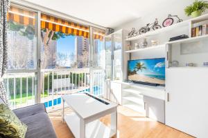 a living room with a tv and a large window at Albatros 2-6 Estudio Levante Beach in Benidorm