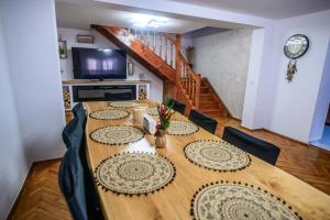 a large wooden table with chairs in a room at Alpine Bliss Sinaia in Sinaia +141 photos
