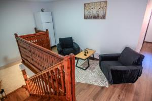 a living room with two chairs and a table at Alpine Bliss Sinaia in Sinaia