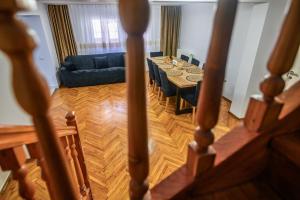 a living room with a table and a blue couch at Alpine Bliss Sinaia in Sinaia