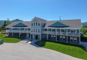 a large white house with a large yard at The Tides Inn in Norris Point