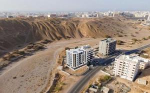an aerial view of a city in the desert at Muscat sand apartments in Muscat