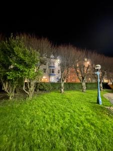 a park at night with a house in the background at The Ocean Guesthouse in Weymouth