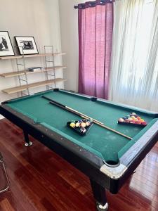 a pool table with cue balls on top of it at Home with Nance in Oshawa