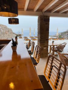 a wooden table and chairs with a view of the ocean at Apostolis Windmill in Psarou