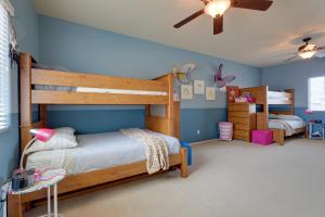 a bedroom with a bunk bed and blue walls at Maricopa Desert Oasis Fenced Yard with Hot Tub in Maricopa +27 photos