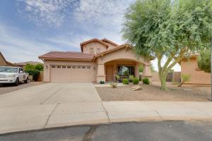 a house with a car parked in front of it at Maricopa Desert Oasis Fenced Yard with Hot Tub in Maricopa