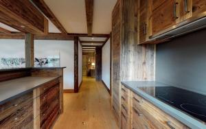 a kitchen with wooden cabinets and a counter top at Giant 7 in St. Moritz