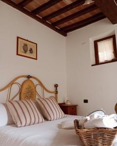 a bedroom with a bed with striped pillows at OLEA casa vacanze in Todi +45 photos