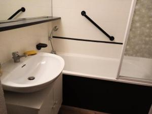 a bathroom with a sink and a shower and a tub at Résidence Le Hameau du Sauget - maeva Home - 2 Pièces 4 Personnes Confort 01 in La Plagne Tarentaise