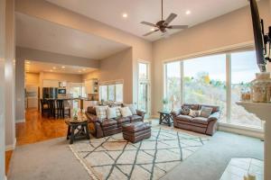 a living room with two couches and a large window at Scenic Hills in North Salt Lake