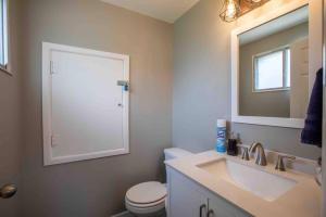 a bathroom with a sink and a toilet and a mirror at Diamond in Sandy +20 photos