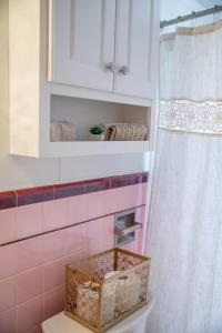 a bathroom with a shower with a basket on the toilet at 237 Center Place in Salt Lake City +23 photos