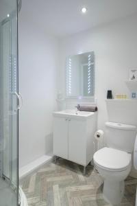 a bathroom with a toilet and a sink and a shower at The Wescoe Guesthouse in Blackpool +35 photos