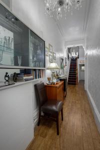 a hallway with a desk and chairs and a staircase at The Wescoe Guesthouse in Blackpool