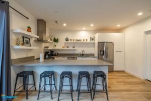 a kitchen with a large island with four bar stools at Navien Nooks Unit 2 in Salt Lake City +33 photos