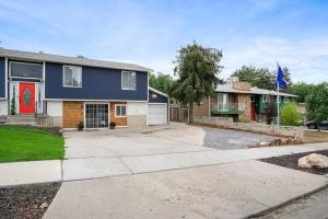 a house with a driveway and a garage at Grumpy Grizzly in Sandy