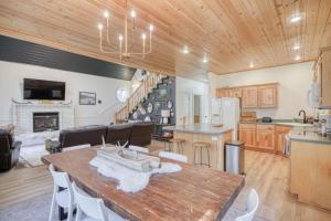 a kitchen and living room with a wooden ceiling at Bills Island Hideaway in Island Park