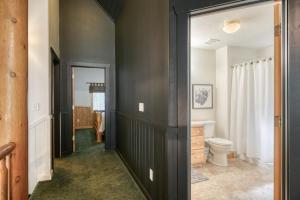 a bathroom with black walls and a toilet in it at Bills Island Hideaway in Island Park +56 photos