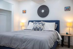 a bedroom with a blue bed with two lamps at Lily Pad in Sandy