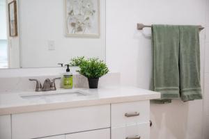 a bathroom with a sink and a green towel at Lily Pad in Sandy +25 photos