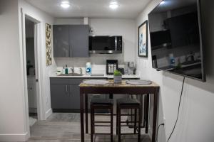 a small kitchen with a small table with stools at Silver Studio in Salt Lake City +5 photos