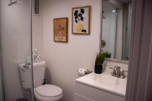 a bathroom with a toilet and a sink and a mirror at Silver Studio in Salt Lake City