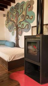 a room with a fireplace with a tree on the wall at Cabaña Costa Azul Los Acantilados in Mar del Plata