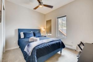 a bedroom with a blue bed with a ceiling fan at Elbert's Escape Sleeps 8 Lakefront Views in Georgetown